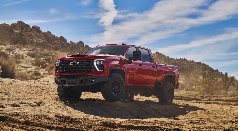 red 2024 Chevy Silverado 2500 HD ZR2 Bison is shown from the front at an angle after looking at a Chevy Silverado for sale.