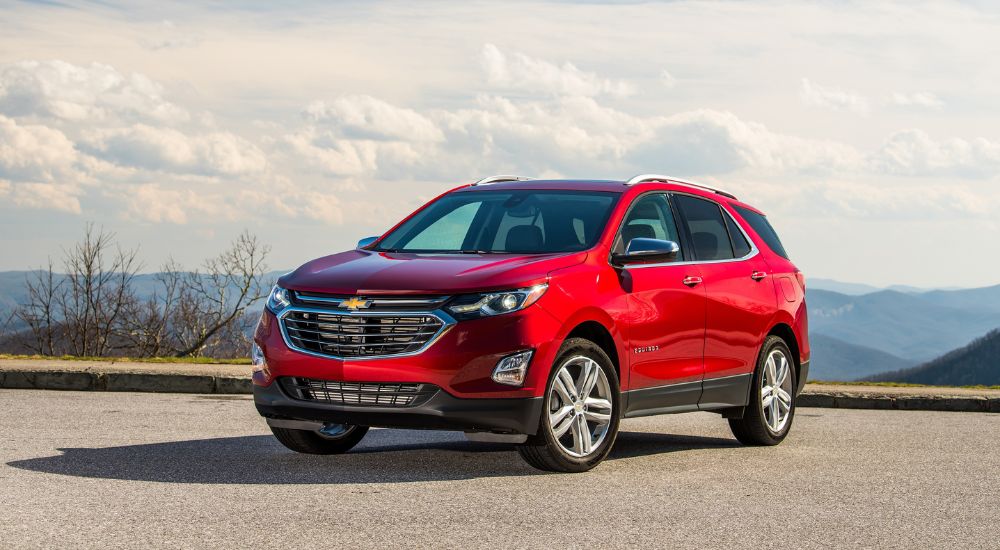 A red 2019 Chevy Equinox is shown parked after visiting a dealership to 'sell my car.'