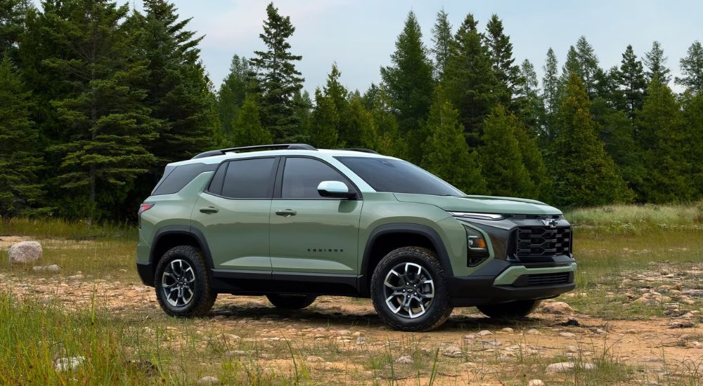 A green 2025 Chevy Equinox is shown parked on a field.