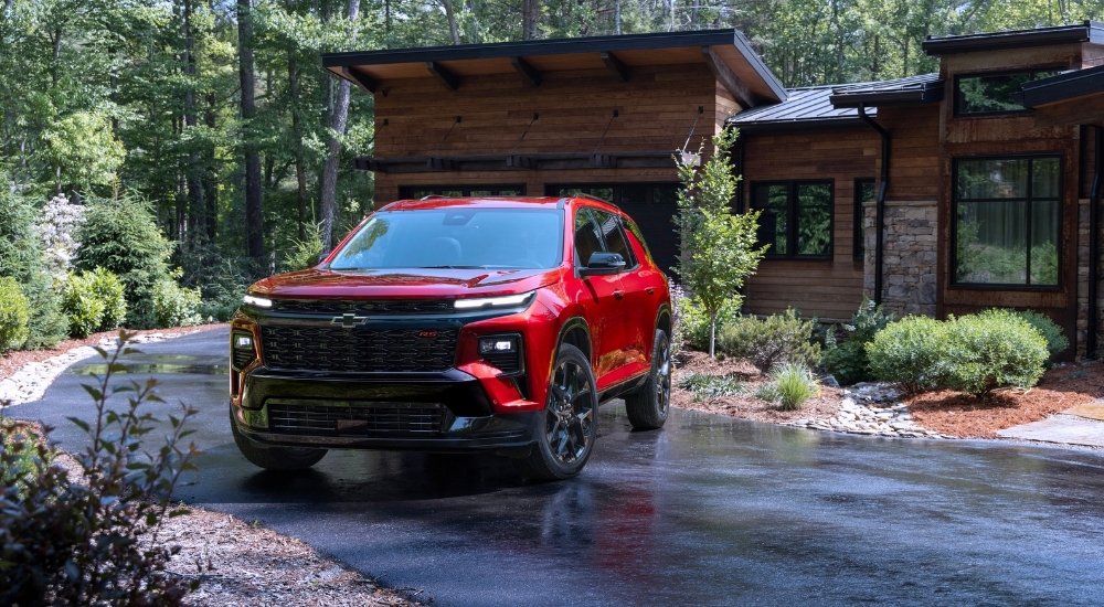 A red 2024 Chevy Traverse parked in a driveway after visiting a Chevy dealer near Baldwyn.