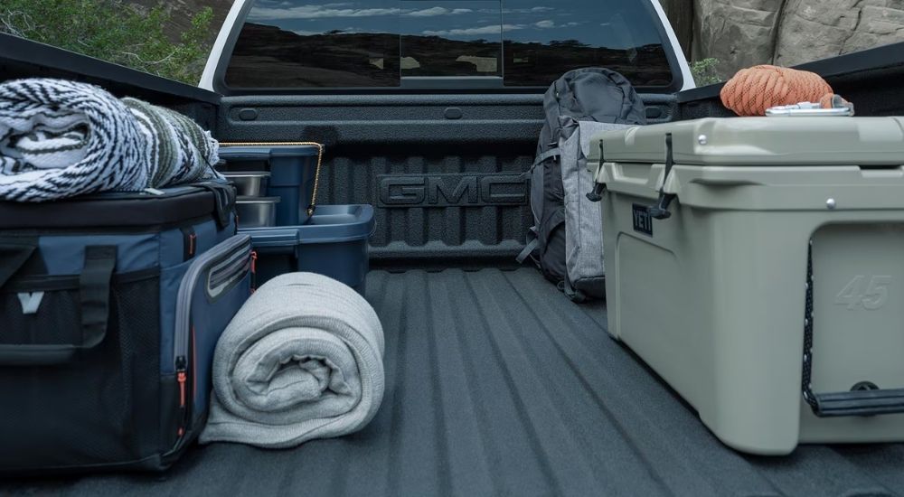 Rear view of camping gear in the bed of a 2025 GMC Canyon for sale.