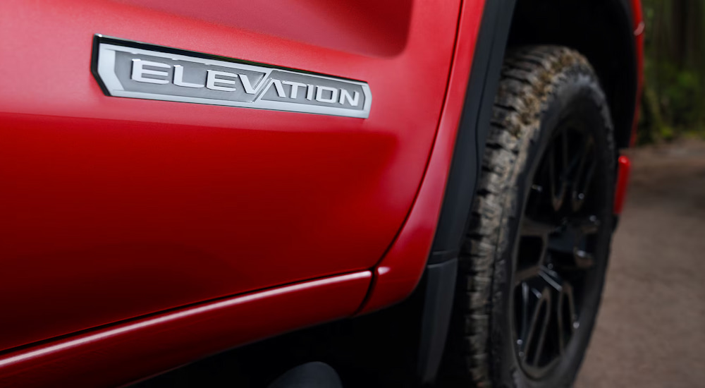 Close-up of the Elevation badge on a red 2025 GMC Sierra 1500 Elevation.