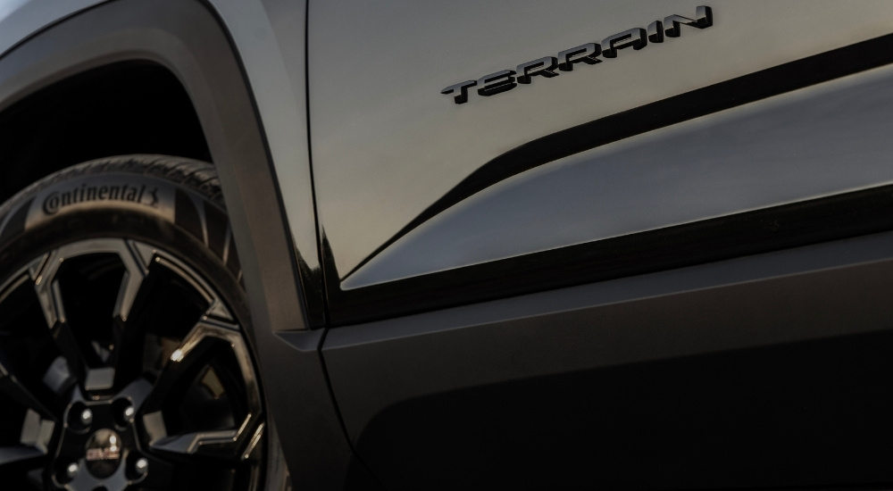 A close-up of the wheel of a black 2025 GMC Terrain.