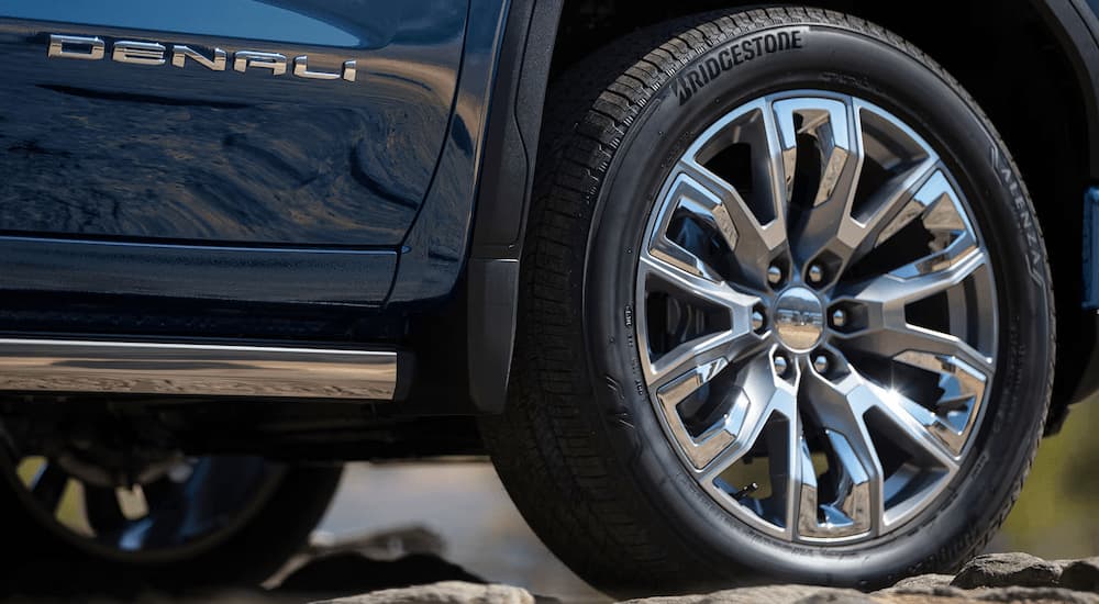 Rim and tire on a blue 2025 GMC Sierra 1500 Denali.
