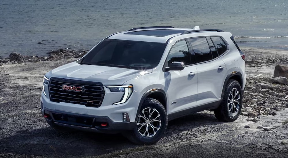 A white 2025 GMC Acadia AT4 parked off-road.