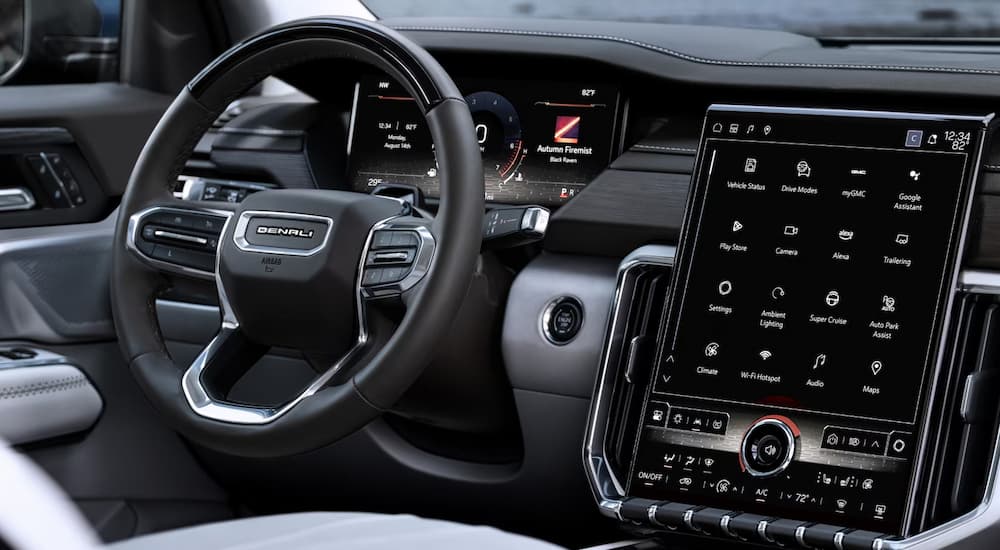 Steering wheel and infotainment screen in a 2025 GMC Acadia for sale near Booneville.