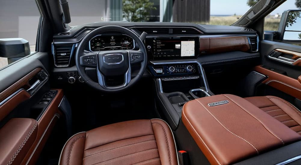 The black and brown interior and dash in a 2025 GMC Sierra 2500 HD for sale.