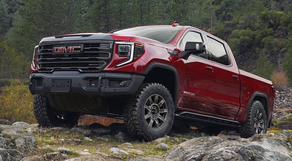 Red 2025 GMC Sierra 1500 driving off-road.