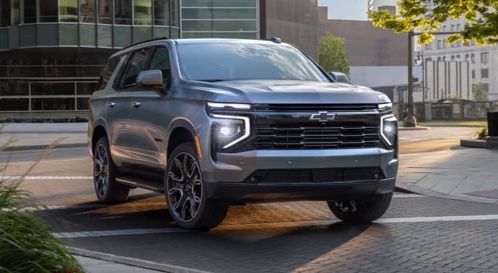A silver 2025 Chevy Tahoe Z71 driving to a Chevy dealer near Burnsville.