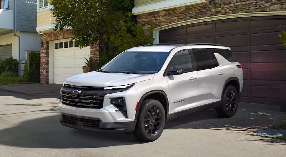 A white 2025 Chevy Traverse parked on a driveway.