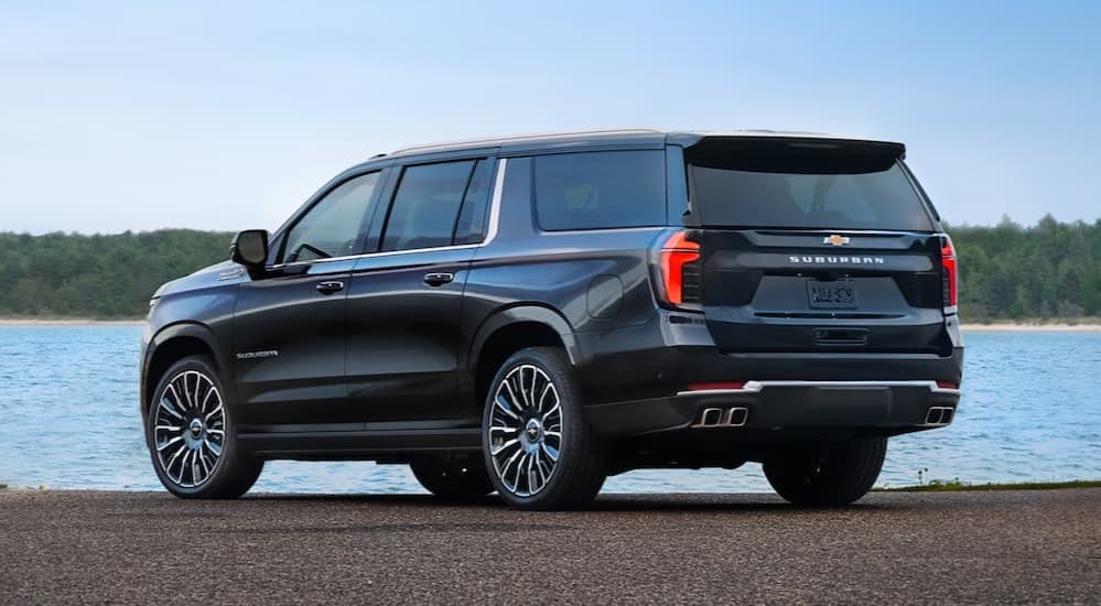 A blue 2025 Chevy Suburban parked near water.