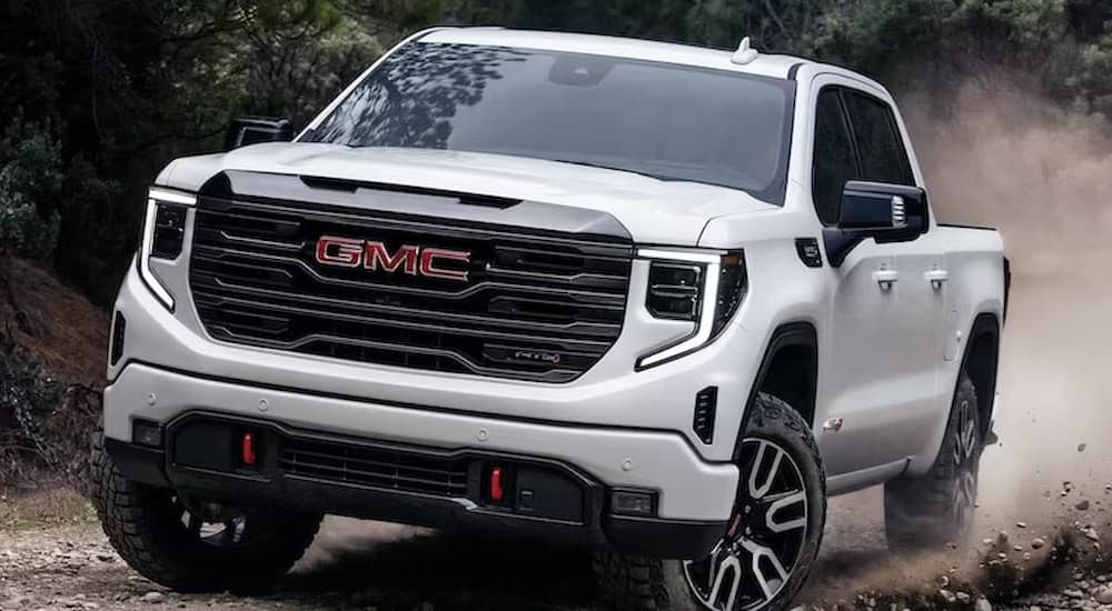 A white 2022 GMC Sierra 1500 AT4 off-roading.