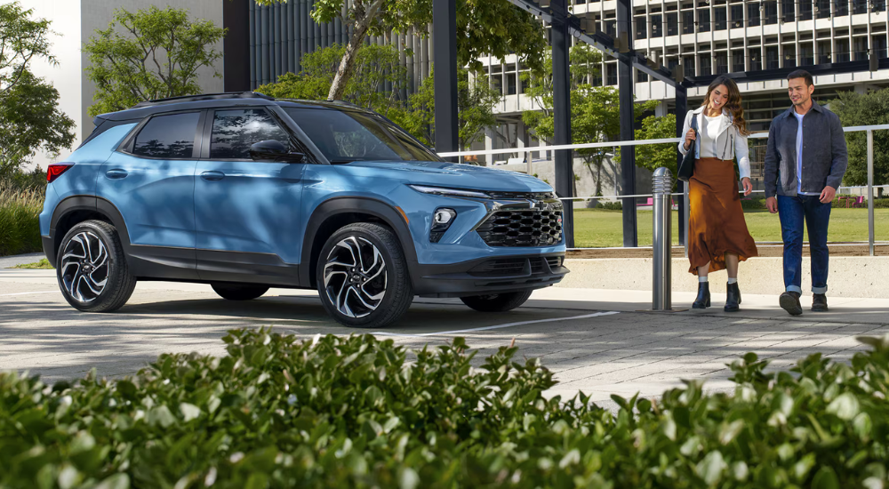 Blue 2026 Chevy Trailblazer for sale with people looking at it