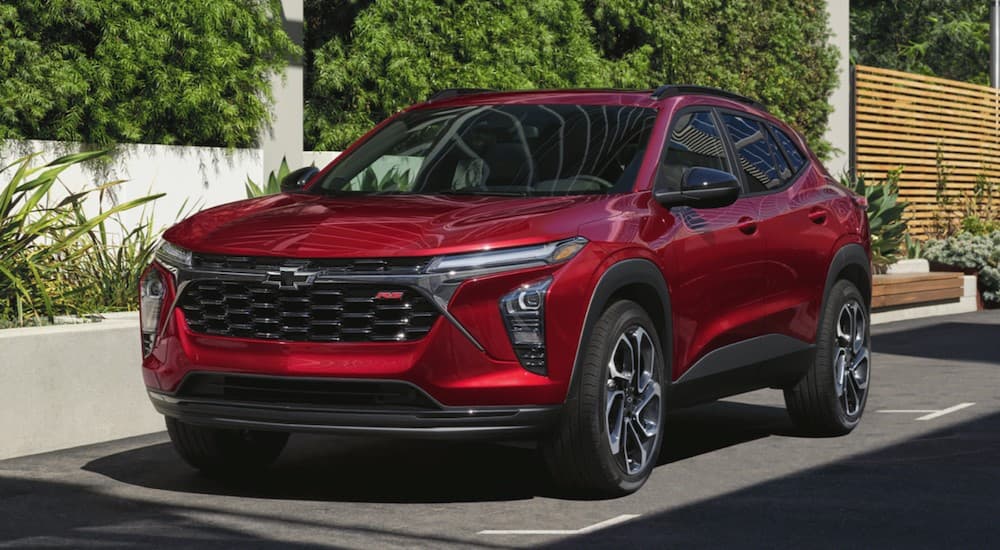A red 2026 Chevy Trax RS parked in a city.