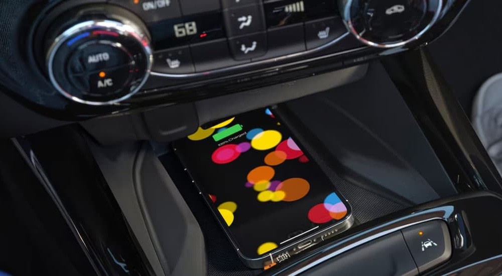A cellphone charging in a 2026 Chevy Trax at a Chevy dealer near Tupelo.