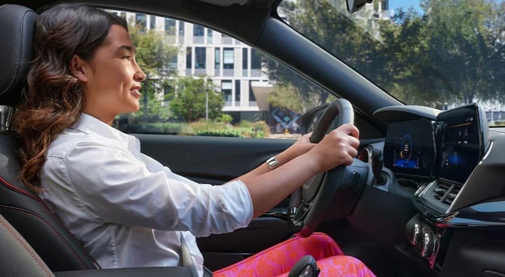 A person driving in a 2026 Chevy Trax.