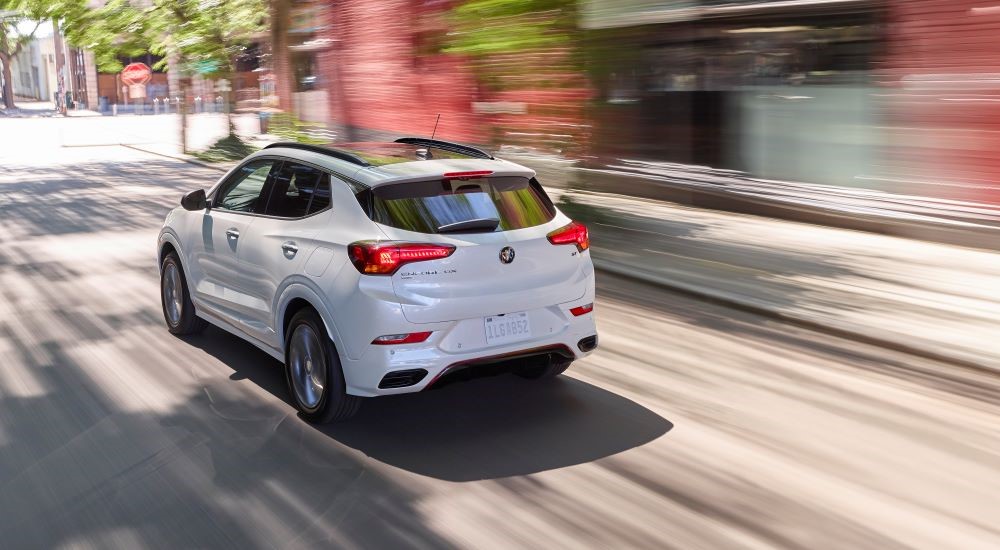 A white 2021 Buick Encore GX is shown on city street after leaving a Tupelo GM dealer.