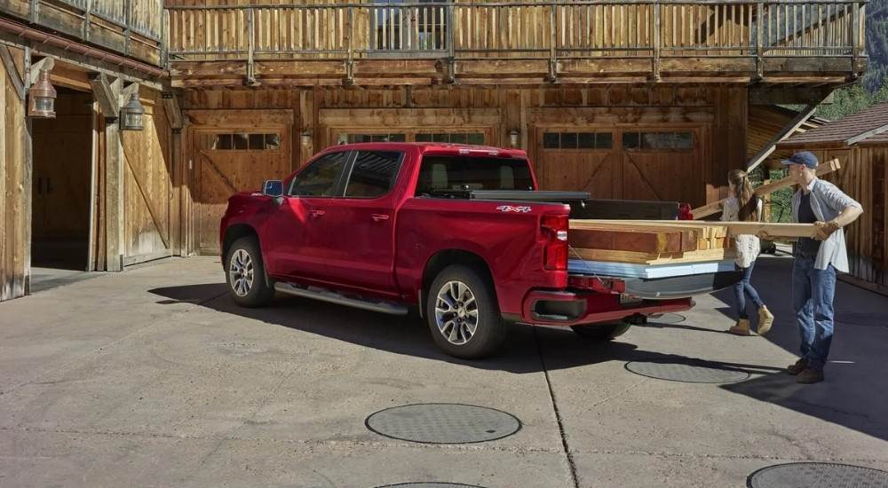 Red 2021 Chevy Silverado 1500 with lumber in the bed