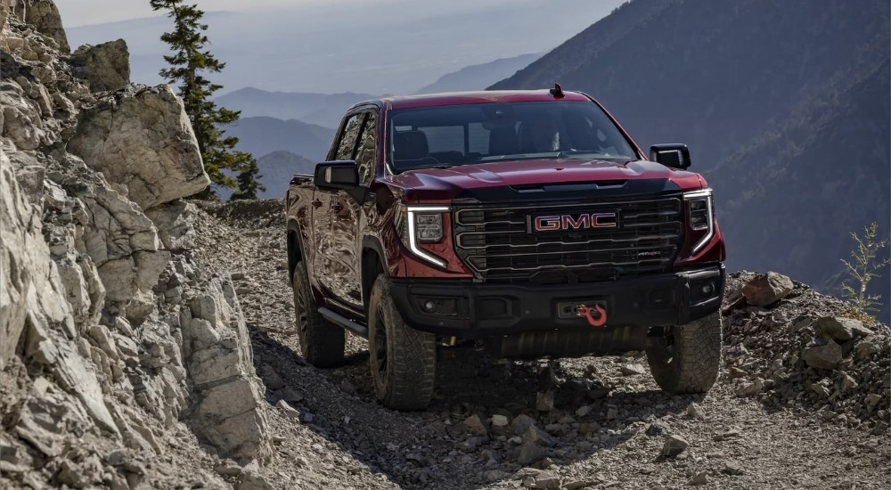 A red 2022 GMC Sierra 1500 AT4X is shown off-road after leaving a Booneville GM dealership.