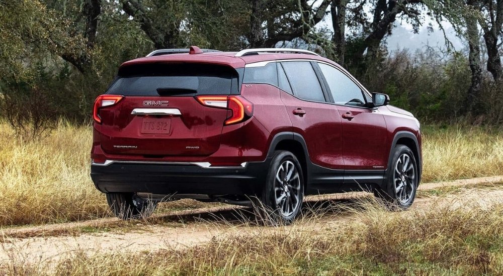 A red  2022 GMC Terrain SLE is shown on a path after a GM lease turn in.