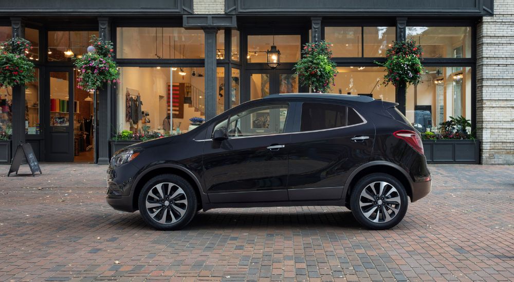 Black 2022 Buick Encore parked in front of a shop