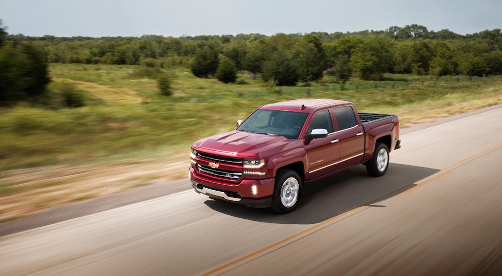 A maroon 2017 Chevy Silverado 1500 LTZ Z71 is shown driving on an open road.