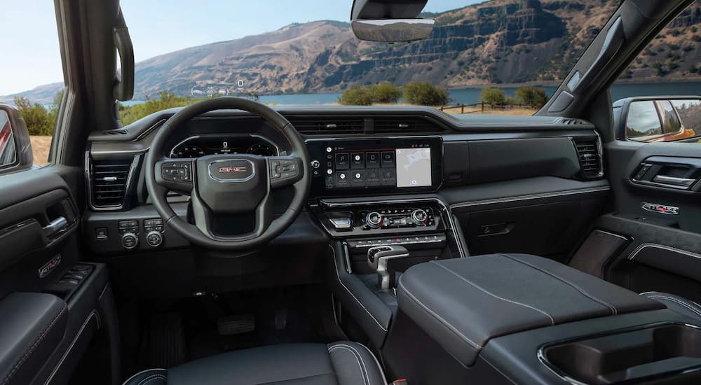 The dash and interior are shown in a 2023 GMC Sierra 1500 AT4X.