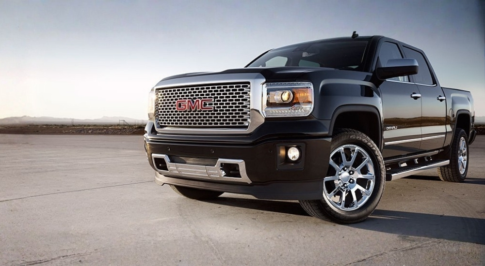 Black 2014 GMC Sierra 1500 Denali parked off-road
