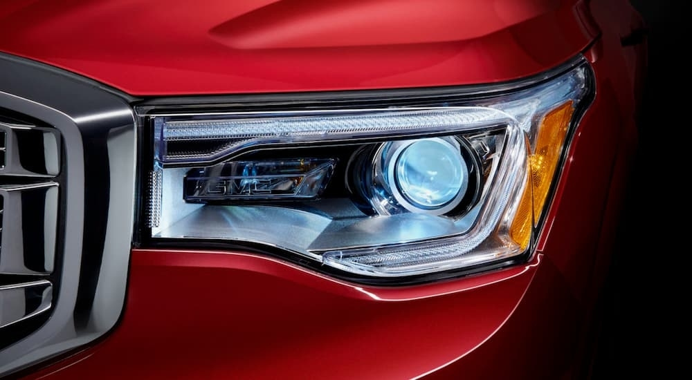 Passenger side headlight on a red 2018 GMC Acadia Denali