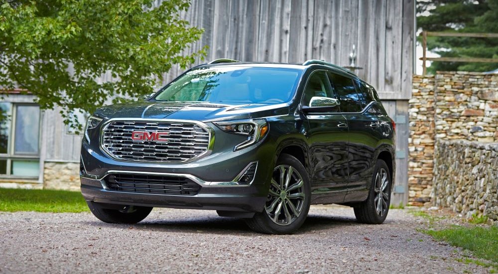 Grey 2020 GMC Terrain Denali  parked in front of a barn