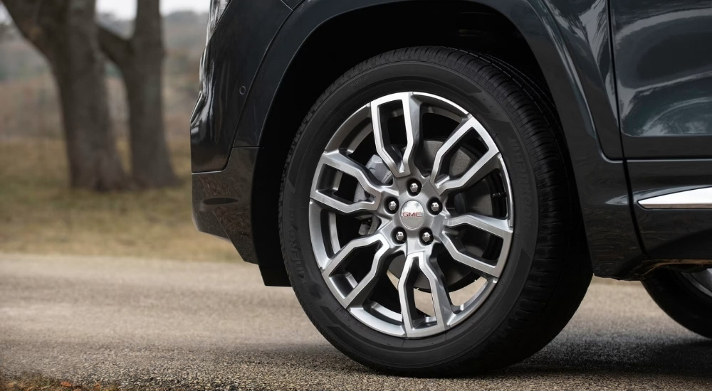 A close up shows a silver wheel on a black 2022 GMC Terrain Denali.