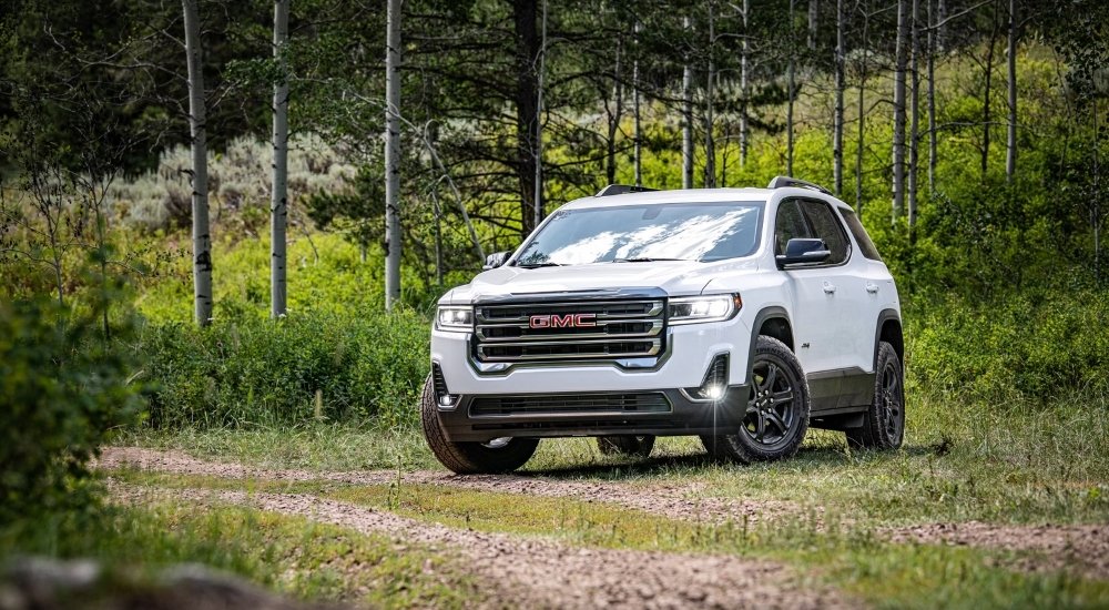 A white 2020 GMC Acadia AT4 parked off-road