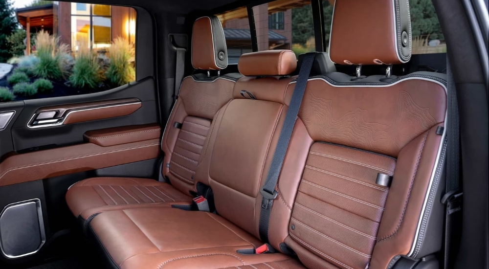 The brown leather seats are shown in a 2024 GMC Sierra Denali Ultimate.