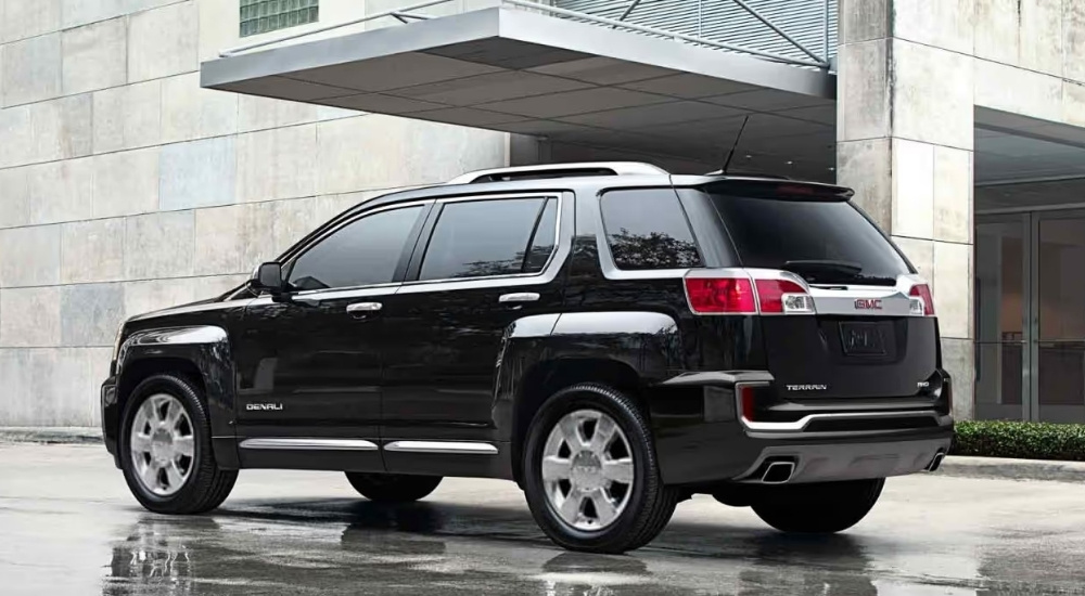 Black 2015 GMC Terrain Denali parked in front of a building