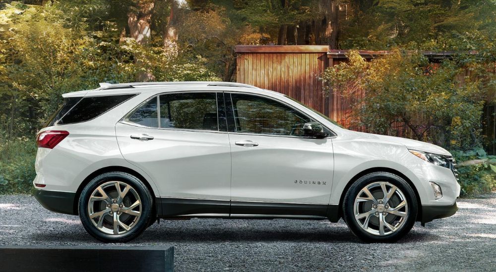 A white 2020 Chevy Equinox is shown parked near a building.