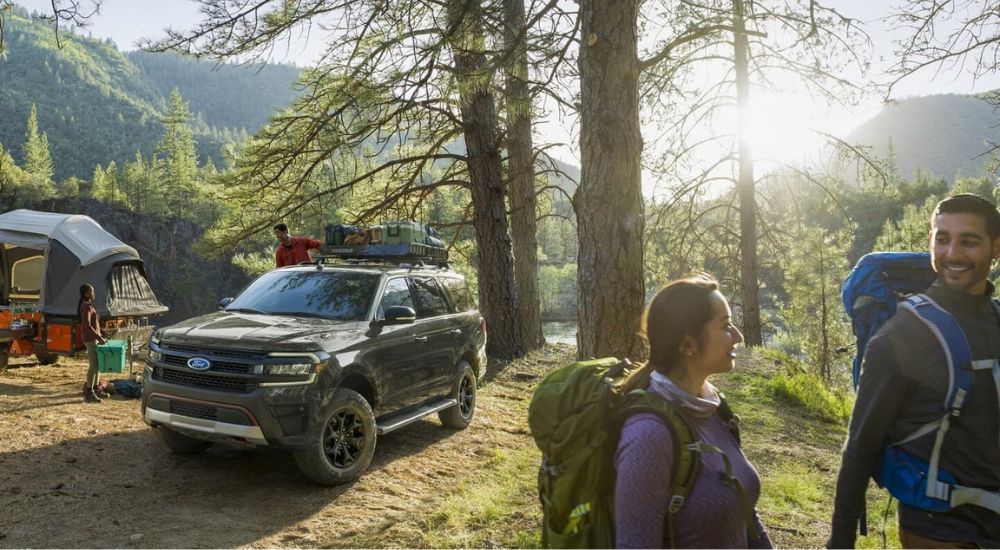 A black 2024 Ford Expedition Timberline is shown at a campsite.