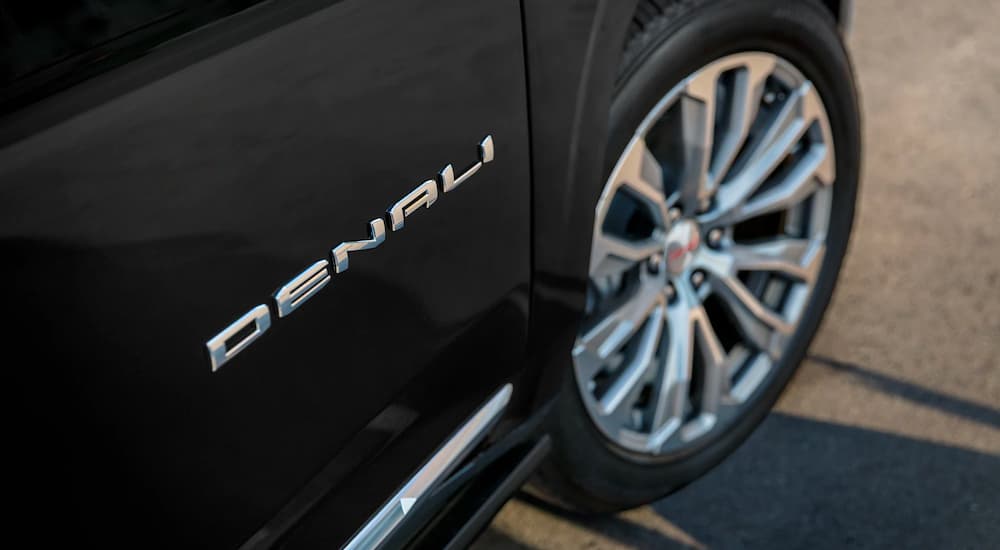 A close-up on the Denali badging on a black 2024 GMC Yukon Denali.
