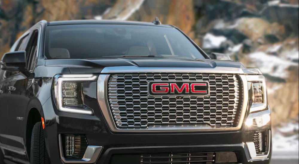A close-up on the grille of a black 2024 GMC Yukon Denali.