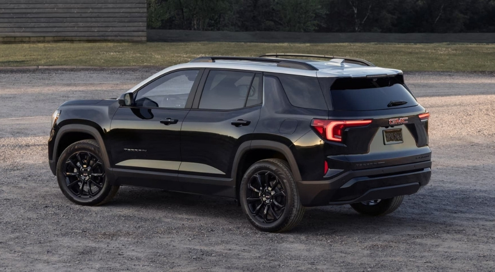 A black 2023 GMC Terrain for sale is shown from the rear.