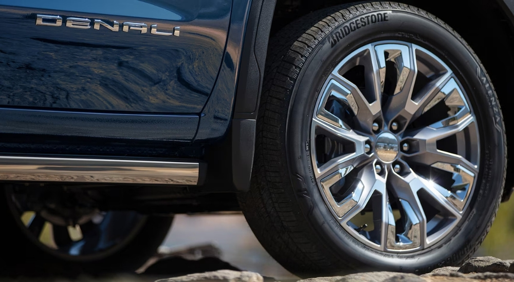 Rim and tire on a blue 2025 GMC Sierra 1500 Denali.