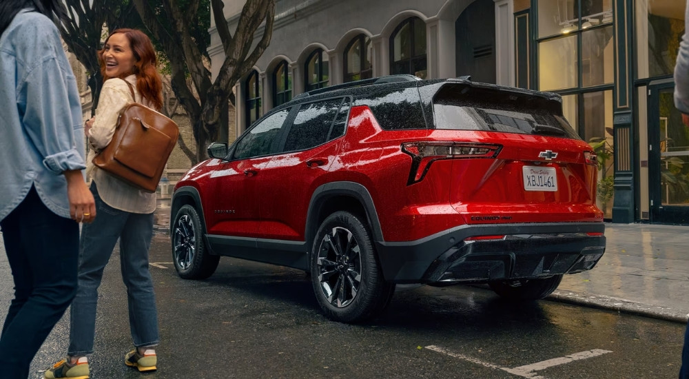 A red 2025 Chevy Equinox RS parked near a stop sign.