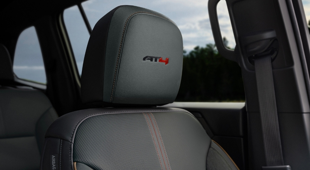 'AT4' badge on the headrest in a 2025 GMC Acadia AT4