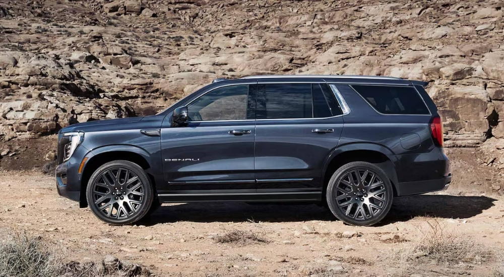A grey 2025 GMC Yukon Denali parked off-road