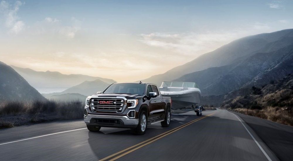 Black 2019 GMC Sierra 1500 SLT towing a boat