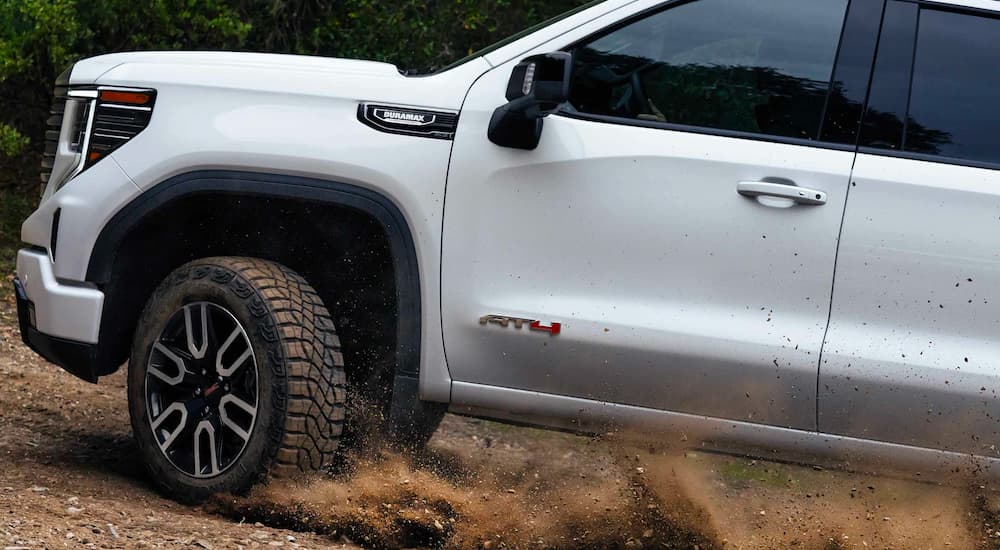 White 2023 GMC Sierra 1500 AT4 kicking up dust