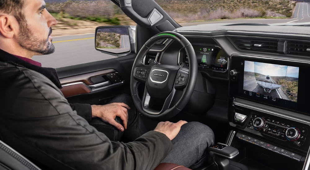 A person driving in a 2026 GMC Sierra 1500.