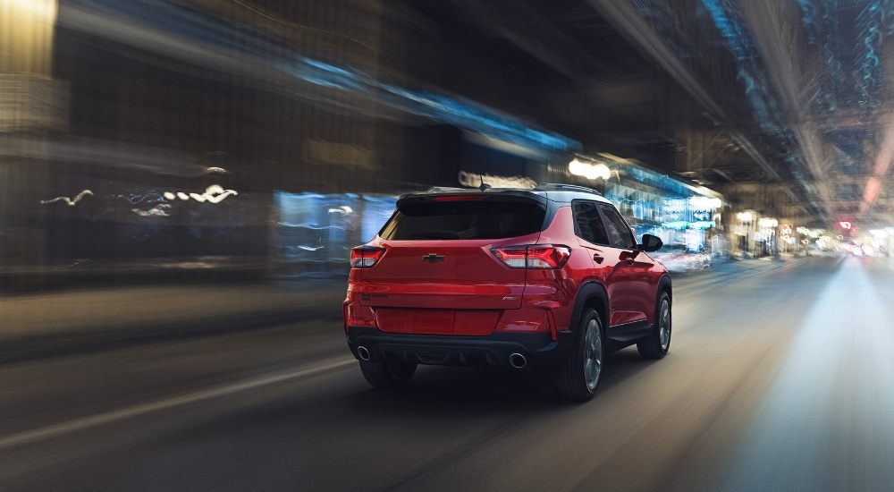 A red 2021 Chevy Trailblazer RS is shown driving through a blurred tunnel.