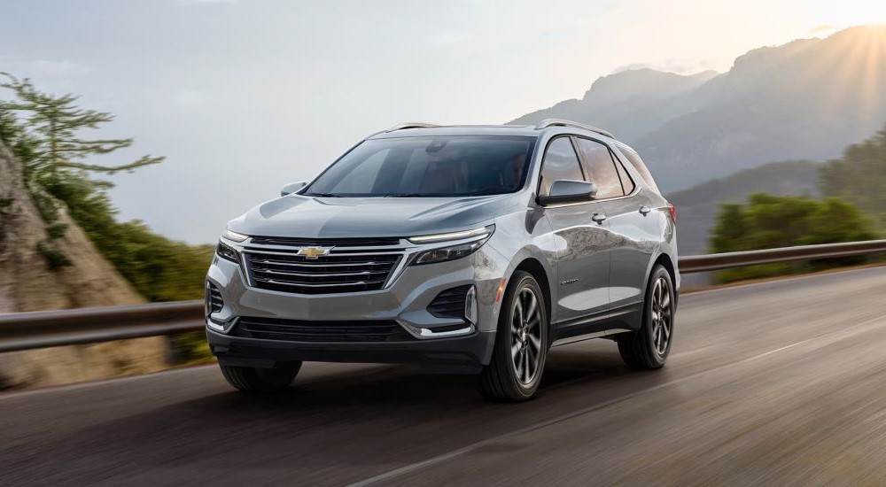A silver 2023 Chevy Equinox is shown from the front at an angle after leaving a dealer that has used cars for sale.