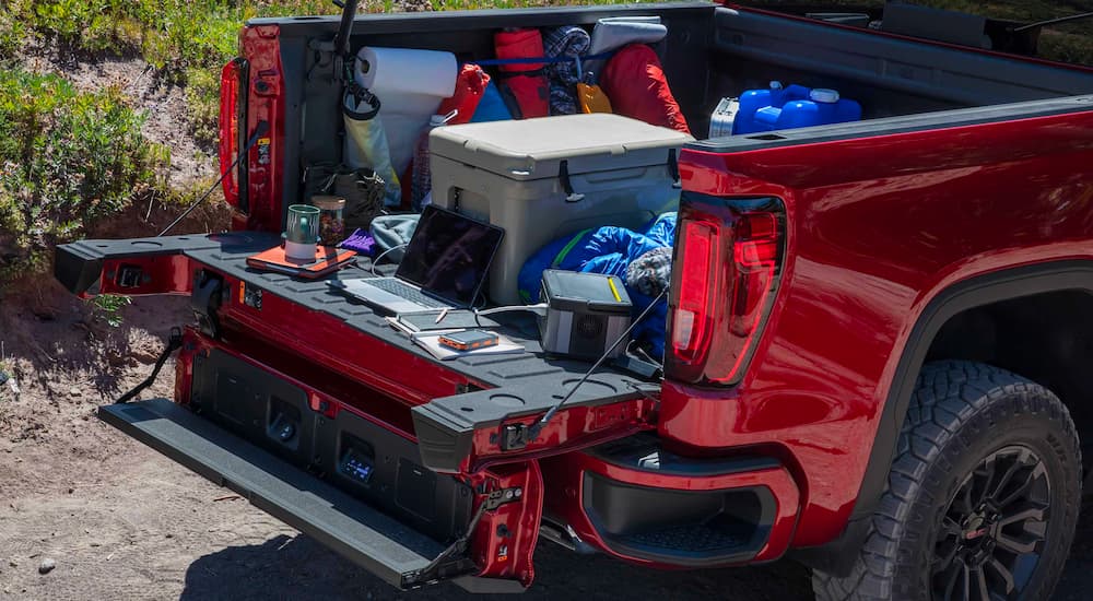 Gear is shown in the rear of a red 2023 GMC Sierra 1500 AT4X.