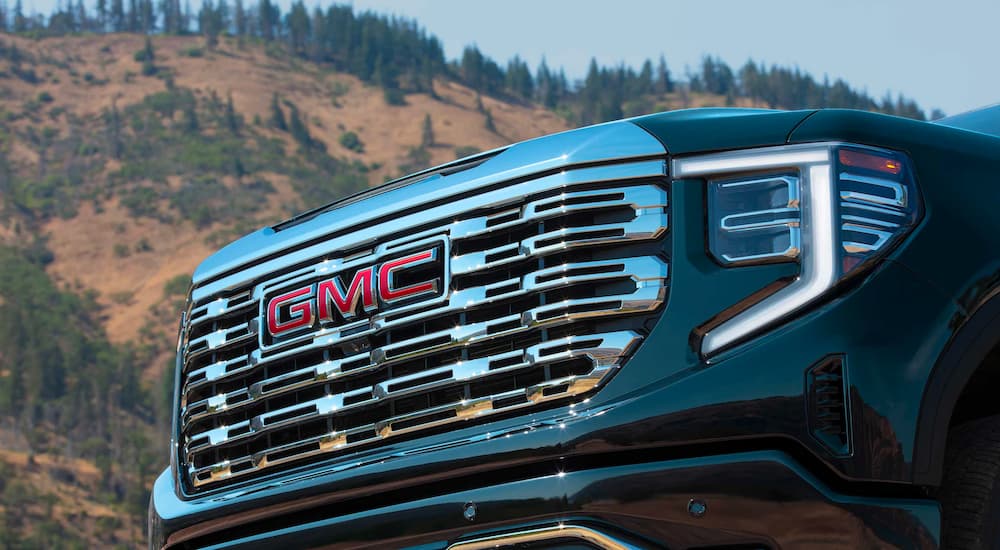 Grille and headlights on a blue 2025 GMC Sierra 1500 Denali for sale in Corinth.